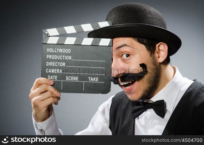 Funny man with movie clapper board