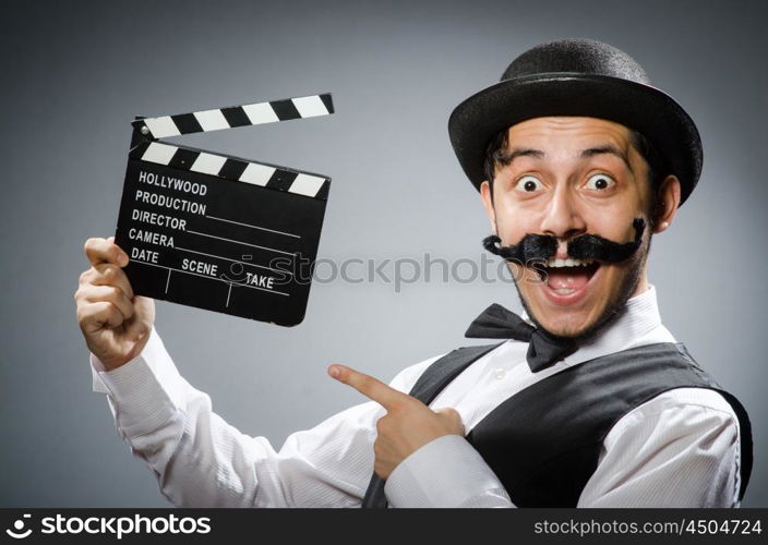 Funny man with movie clapper board