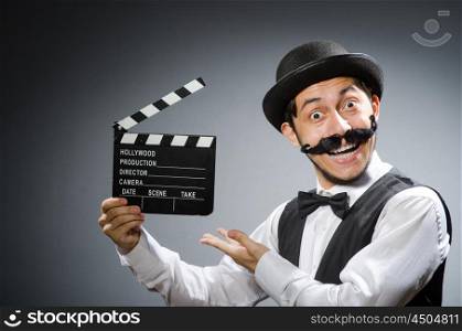 Funny man with movie clapper board