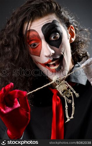 Funny man with skeleton in hands