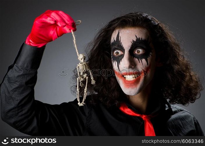 Funny man with skeleton in hands