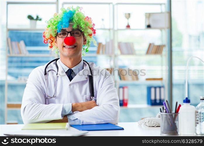 Funny pediatrician with clown wig in the hospital clinic. The funny pediatrician with clown wig in the hospital clinic