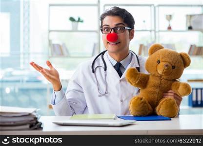 Funny pediatrician with toy in the hospital clinic