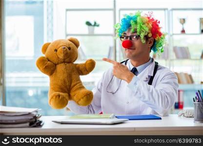 Funny pediatrician with toy in the hospital clinic