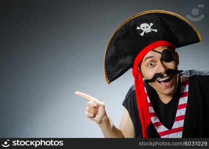 Funny pirate in the dark studio