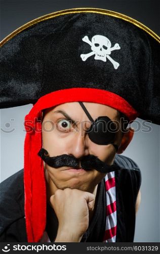 Funny pirate in the dark studio