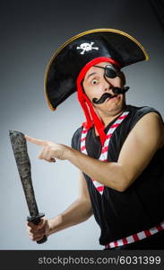 Funny pirate in the dark studio