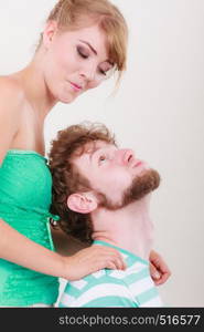 Funny playful young couple making silly face blonde girl and bearded guy studio shot