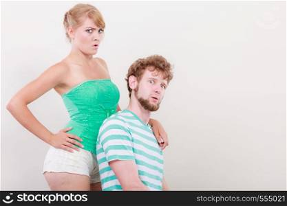 Funny playful young couple making silly face blonde girl and bearded guy studio shot
