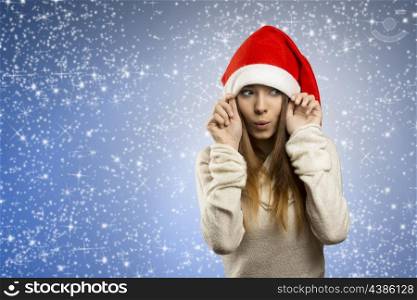 funny portrait of attractive young woman with long smooth hair, warm sweater and red santa claus hat &#xA;