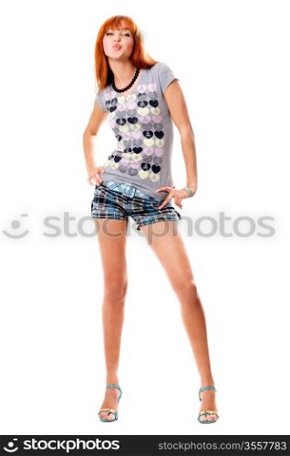 Funny red-haired girl in a t-shirt and shorts