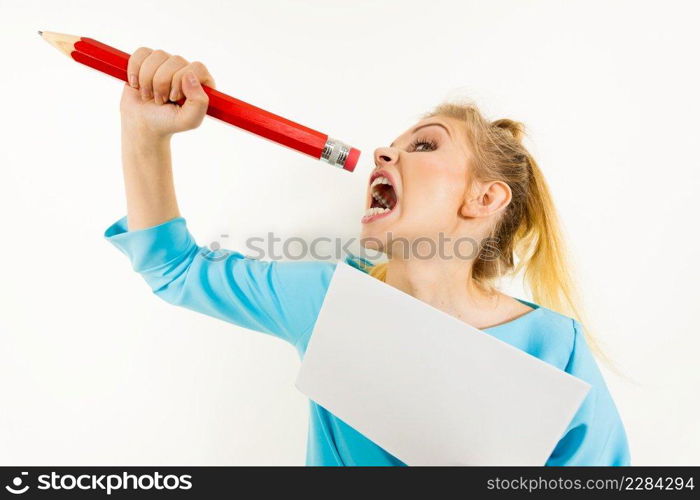 Funny≠rvous woman being stressed out about work or school. Teena≥fema≤holdingπece of paper and biting big oversized pencil. Funny woman biting big pencil