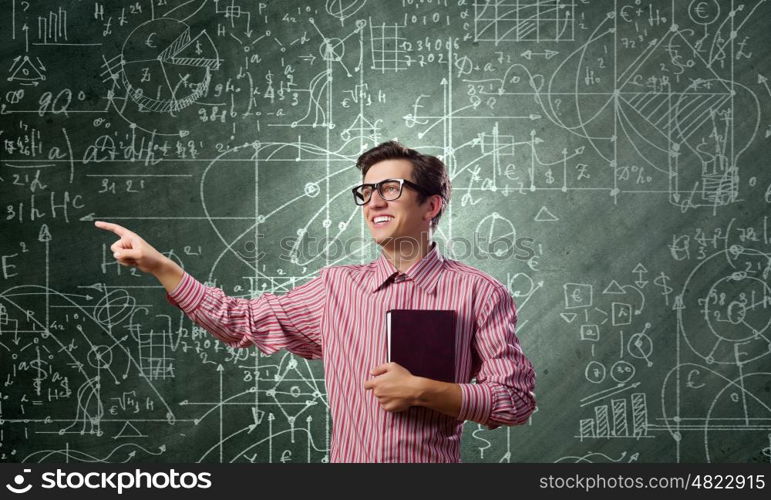 Funny scientist. Young funny man in glasses against chalk blackboard