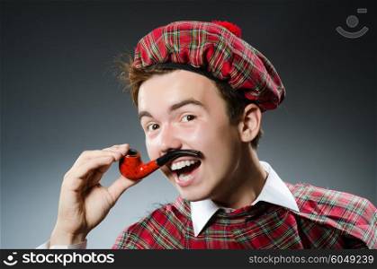 Funny scotsman smoking pipe tobacco