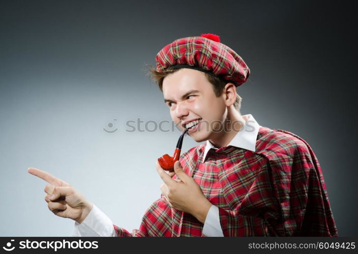 Funny scotsman smoking pipe tobacco