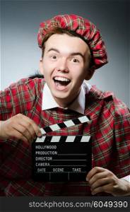 Funny scotsman with movie clapboard