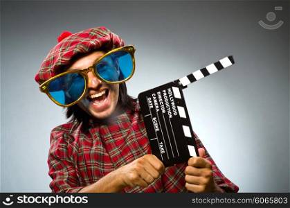 Funny scotsman with movie clapboard