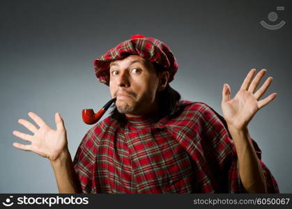 Funny scotsman with smoking pipe