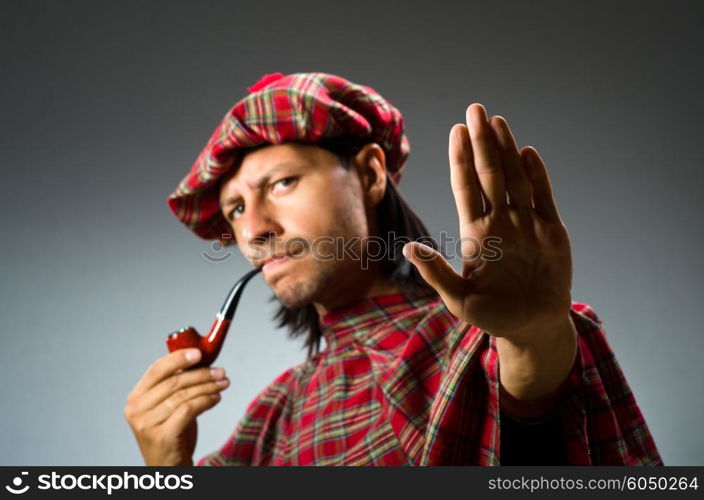 Funny scotsman with smoking pipe