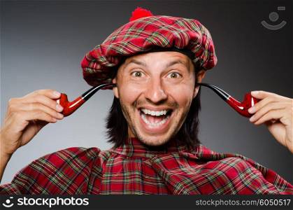 Funny scotsman with smoking pipe
