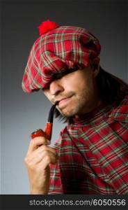 Funny scotsman with smoking pipe