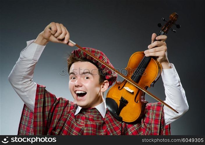 Funny scotsman with violin fiddle