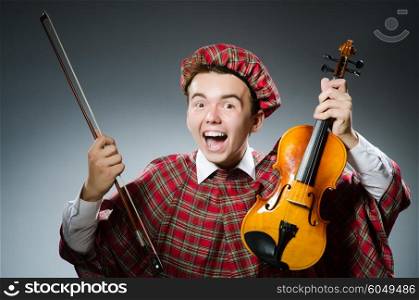 Funny scotsman with violin fiddle