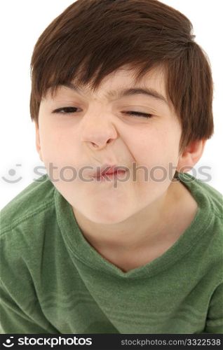 Funny seven year old french american boy making sneeze or nose tickle face.