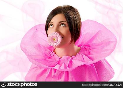funny shot of a young nice girl looking up with pink collar paper keeping a flower in her mouth