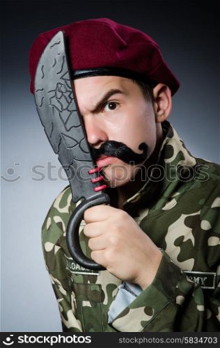 Funny soldier against the dark background