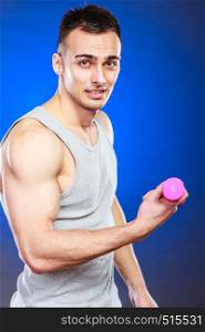 Funny sporty fit man lifting light dumbbell weight. Young muscular strong guy training. Bodybuilding exercise fun.. Funny sporty fit man lifting light dumbbell. Fun.