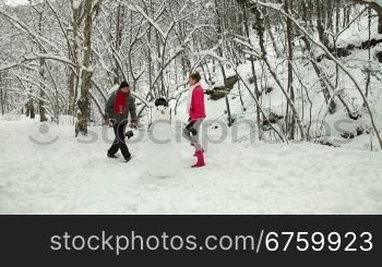 Funny Teenage Couple Enjoying in Snow and Winter
