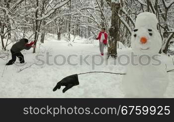 Funny Teenage Couple Enjoying in Snow and Winter