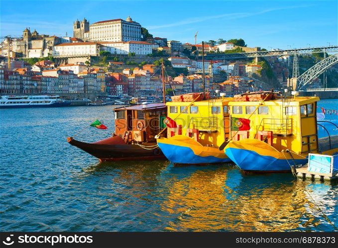 Funny touristic boats on Douro river at sunset. Porto Old Town on a background. Portugal