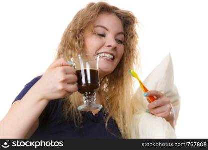 Funny woman holding black coffee and toothbrush being late. Getting morning energy, hurry up before going to work.. Funny woman being late drinking coffee
