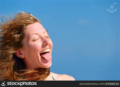 funny woman shows her tongue. A lot of copy space