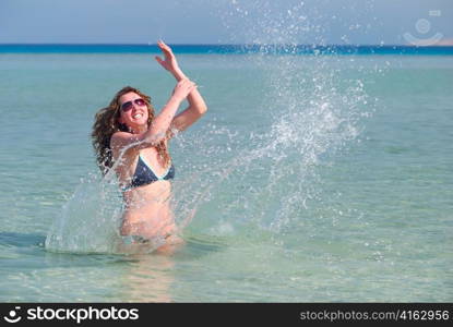 funny woman splasing in the sea