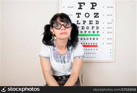 Funny woman wearing spectacles in an office at the doctor