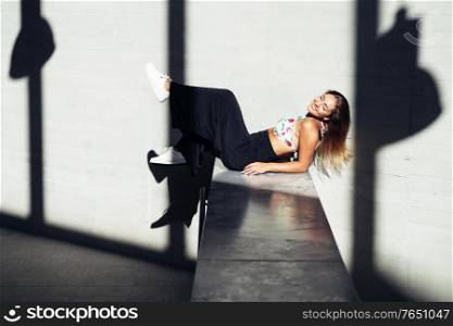 Funny young girl moving her legs in an urban background. Young girl moving her legs in an urban background