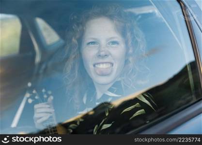 funny young woman fooling around car
