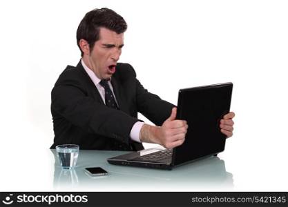 Furious businessman in front of his laptop