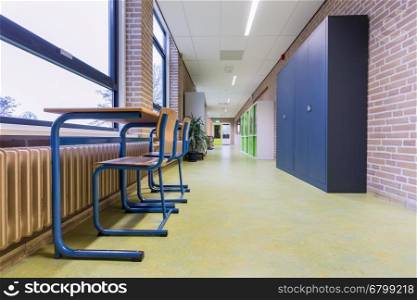 Furniture and storage cupboards in high school corridor