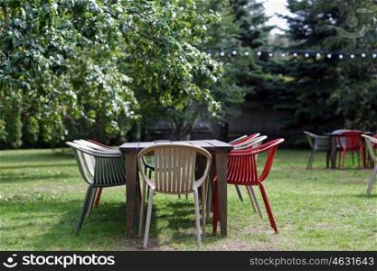 furniture concept - table with chairs at summer garden or outdoor cafe. table with chairs at summer garden