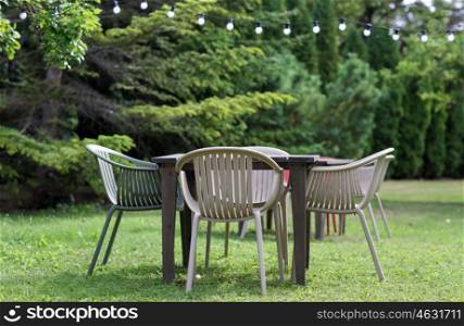 furniture concept - table with chairs at summer garden or outdoor cafe. table with chairs at summer garden