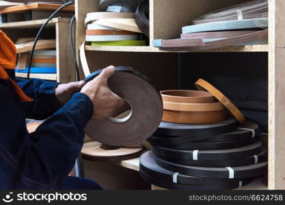 Furniture production concept: man working at furniture factory. Furniture production concept