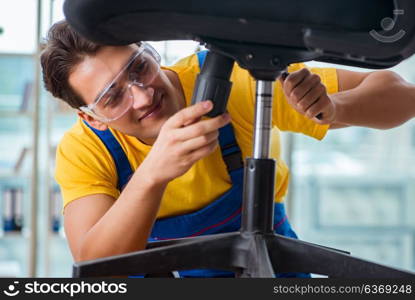 Furniture repairman working on repairing the chair