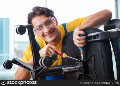 Furniture repairman working on repairing the chair. The furniture repairman working on repairing the chair