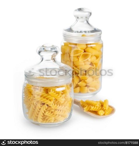 Fusilli and conchiglioni in glass jar isolated on white background. Two different types of raw pasta in glass jars, ingredient for cook, traditonal italian cuisine.