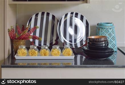 Fusilli jars and stripe plate setting on the counter