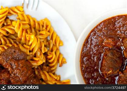 fusilli pasta al dente with neapolitan style ragu meat sauce very different from bolognese style